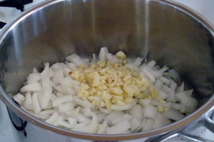 Sauteing onions and garlic in olive oil for barbecue sauce.
