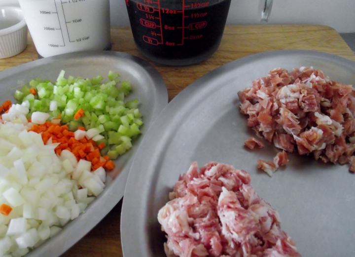 Ingredients for Bolognese sauce: onion, celery, carrot, pancetta, prosciutto, red wine and milk.