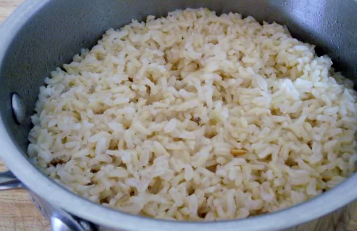 Cooked brown rice in a saucepan.