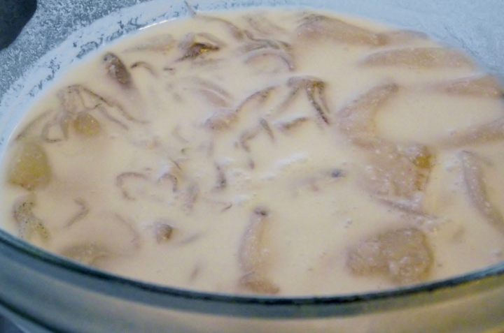 Macerating the calamari in coconut milk.