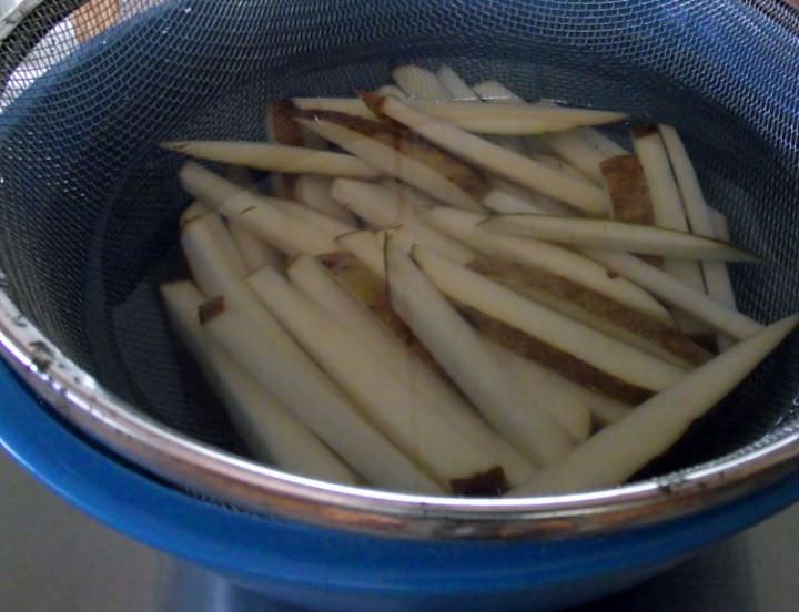 French fries soaking in water.