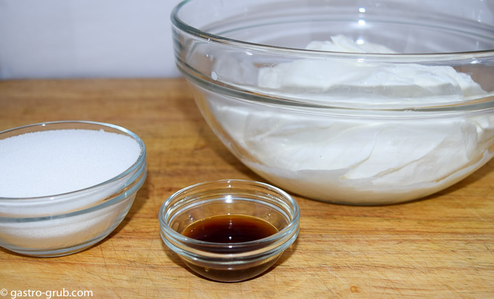 Ingredients for cheesecake topping: sour cream, sugar, and vanilla.