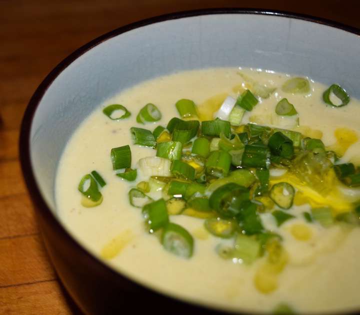 Broccoli cheese soup with green onions and olive oil.