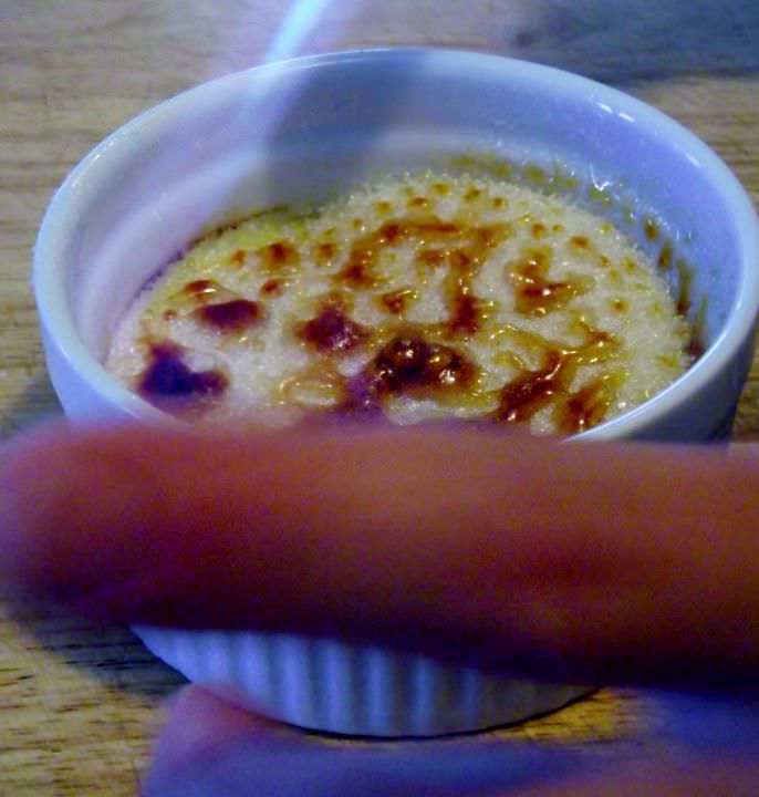 Caramelizing a creme brulee with a torch.