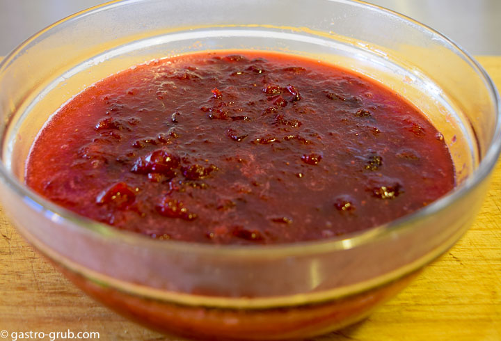 Homemade cranberry sauce cooling in a bowl.