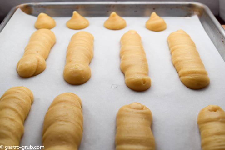 Pastry dough piped onto a sheet pan.