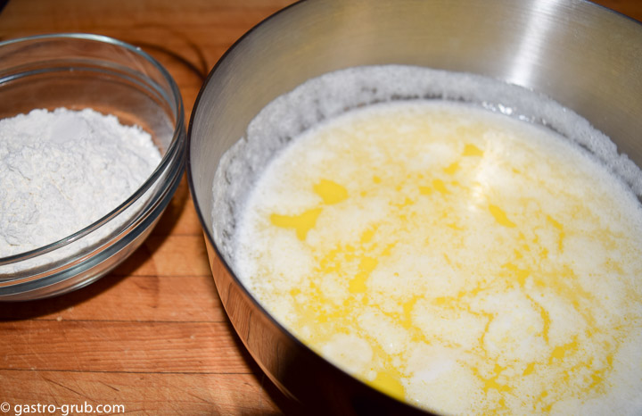 Flour in a bowl and butter milk mixture in a pot.