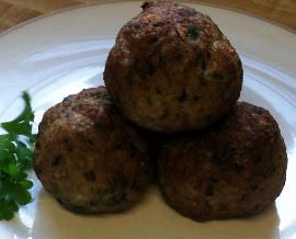 Meatballs on a plate with parsley.