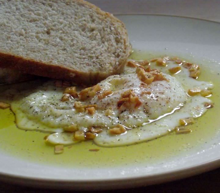 Garlic fried egg with homemade bread and olive oil.