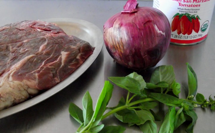 Ingredients for spaghetti sauce with meat: boneless chuck, red onion, fresh sweet basil, and San Marzano tomatoes.