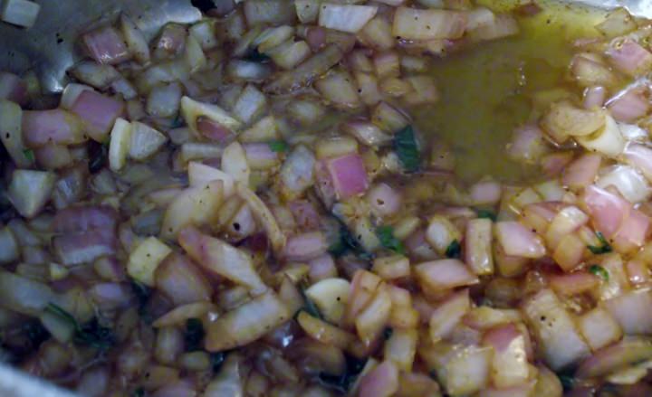Sweating onions, garlic, and basil in olive oil.