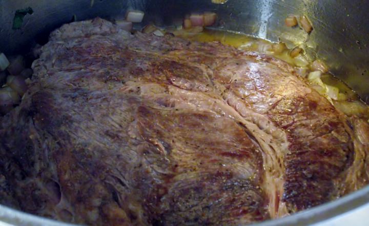 Adding the chuck back into the pot on top of the onions.