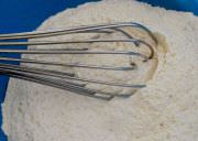Whisking dry ingredients together.