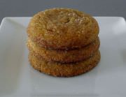 Stacked molasses cookies on a plate.