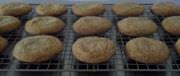 Molasses cookies cooling on a rack.