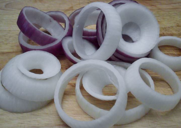 Raw onion slices prepped for onion rings.