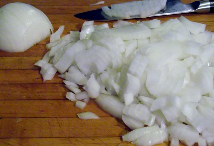 Diced onions on a cutting board.