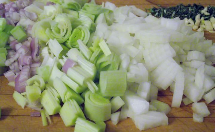 The aromatic vegetables and herbs: diced leeks, onion, shallot, garlic, celery, rosemary, and thyme.