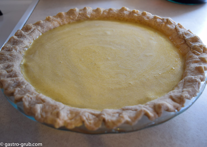 Adding the pie filling to the pie crust.
