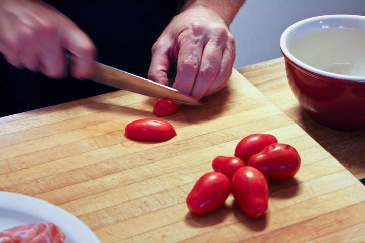Slicing homegrown roma tomatoes.