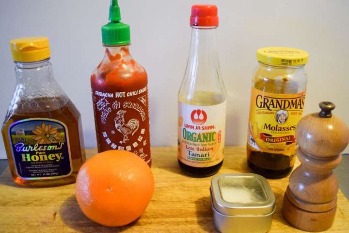 Ingredients for duck glaze: orange juice, honey, tamari, molasses, siracha, salt, and pepper.