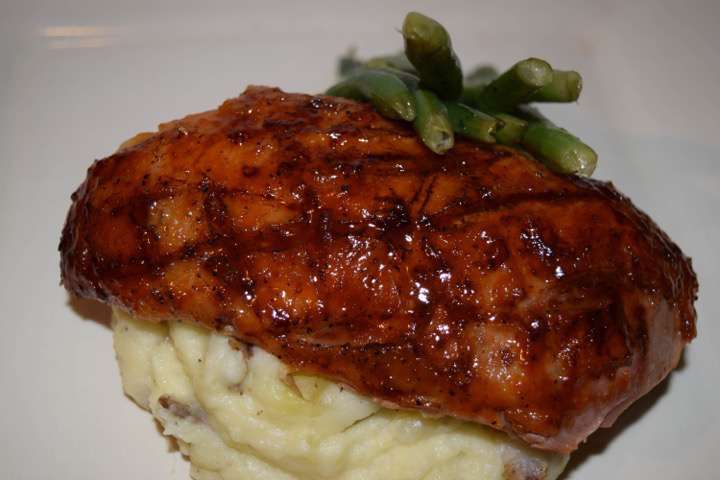 Glazed duck breast with mashed potatoes and green beans.