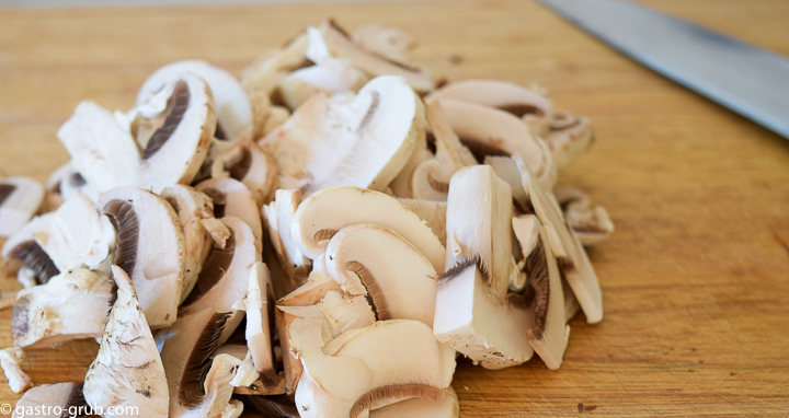 Sliced mushrooms on a cutting board.