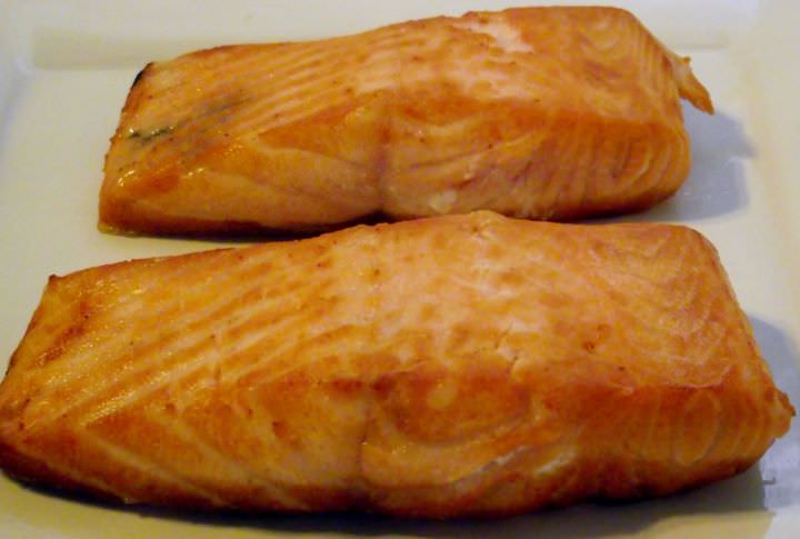 Seared salmon resting on a plate.