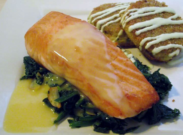 Potato croquettes with green onion aioli and salmon on sauteed greens with beurre blanc.