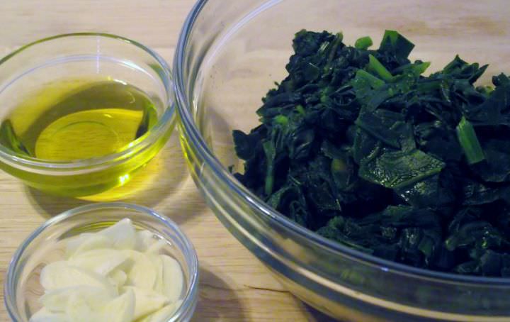 Boiled greens, sliced garlic, and olive oil.