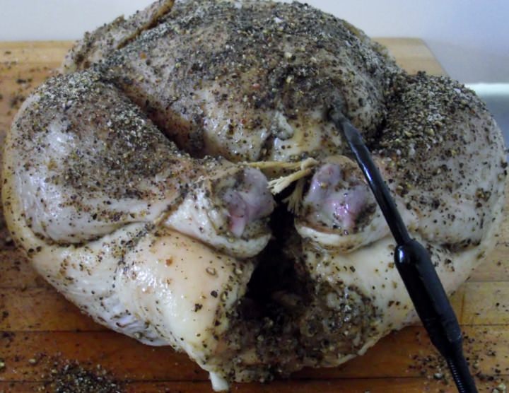 Chicken with temperature probe inserted into the breast.