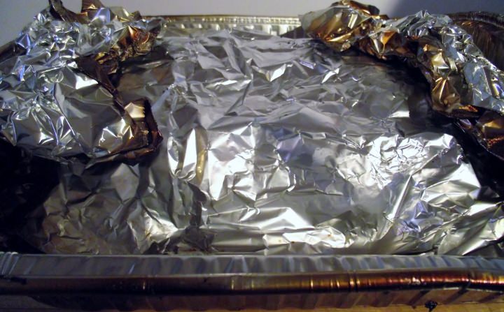 Smoked chicken wrapped in foil.