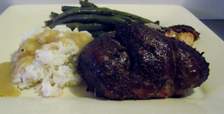 Smoked chicken, rice with smoked chicken gravy, and green beans on a plate.