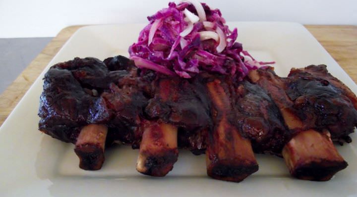 Center cut smoked beef ribs with blanched red cabbage slaw.