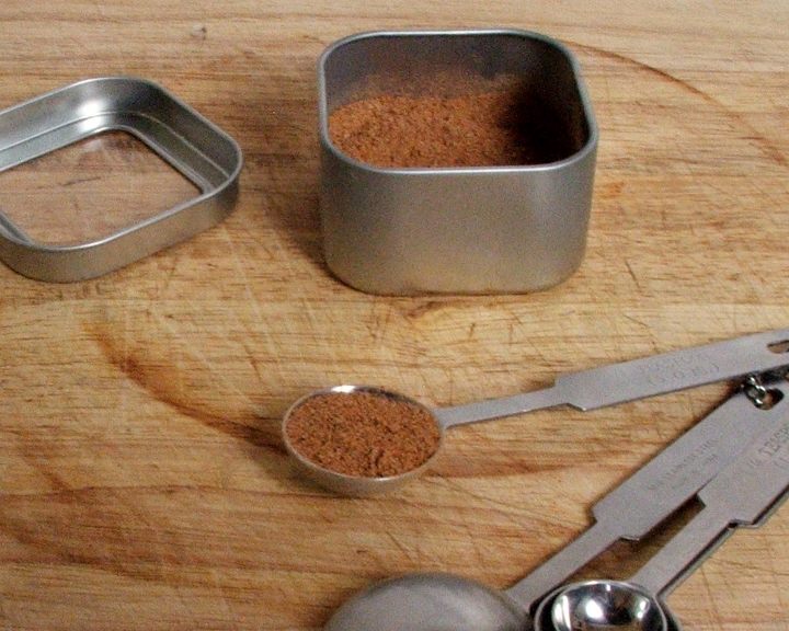 Measuring spoon and spice tin with homemade pumpkin pie spice.