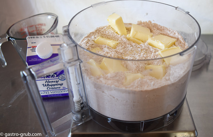 Dry ingredients and butter for shortcake dough in a food processor bowl.