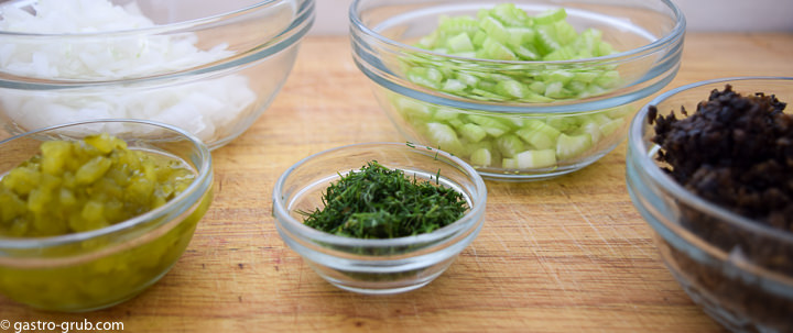 Ingredients for my easy macaroni salad recipe: onion, celery, olives, dill pickle and fresh dill.