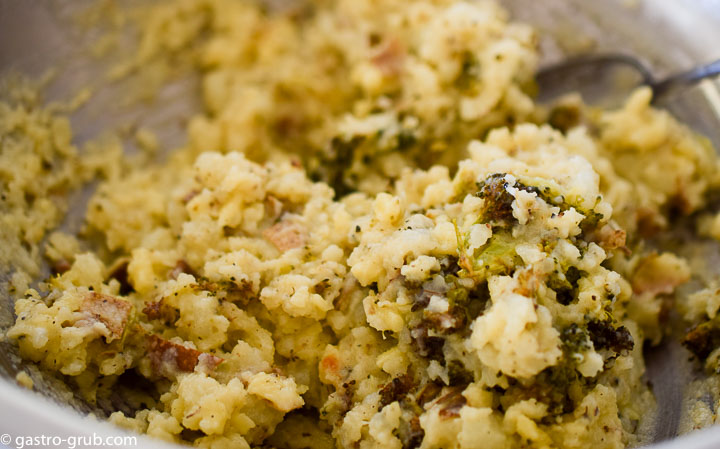 Mixing the potatoes with the butter, broccoli, and cheese.