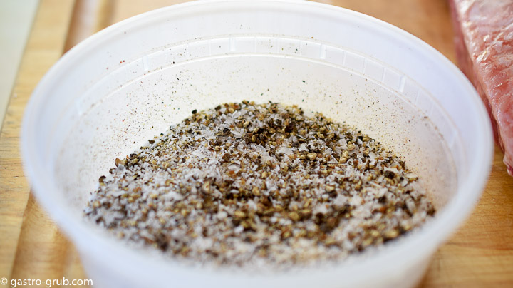 Salt, pepper, and garlic powder mixed in a plastic container.