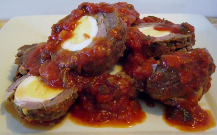 Braciole in sauce on a plate.