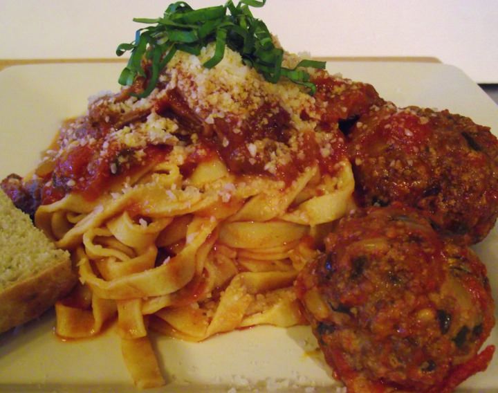 Homemade fettucine, spaghetti sauce with meat, Italian meatballs and rosemary bread.