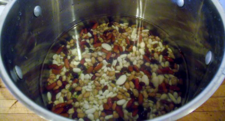 Beans in a pot with water for rinsing.