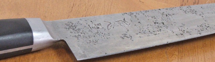 Carbon steel knife showing pitting of the blade.