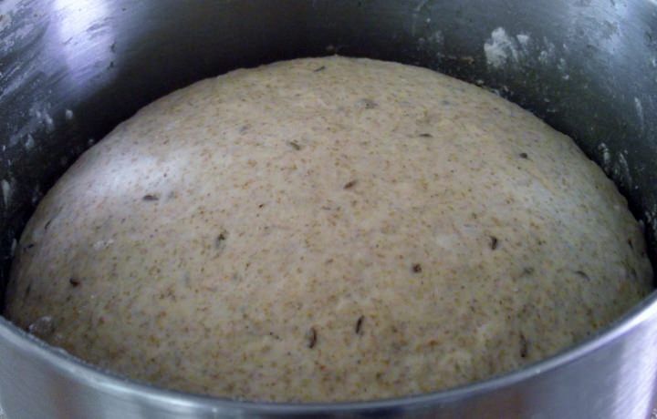 Rye dough rising in a bowl.