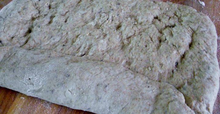 Rolling the rye bread loaf.