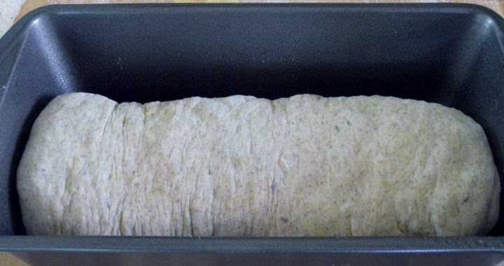 Rye bread loaf in a loaf pan.