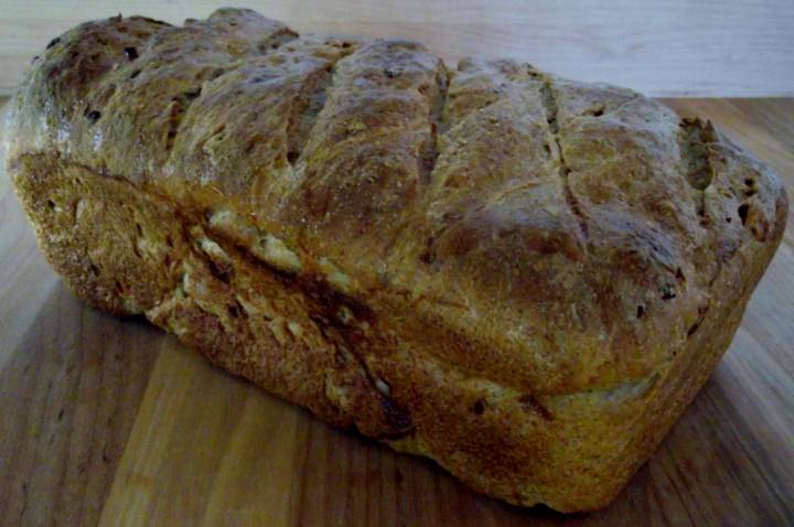 Loaf of rye bread on a cutting board.