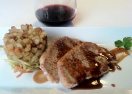 Seared pork with a pan reduction, broccoli slaw, and fried potatoes.