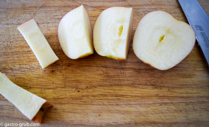 An apple cut into quarters.