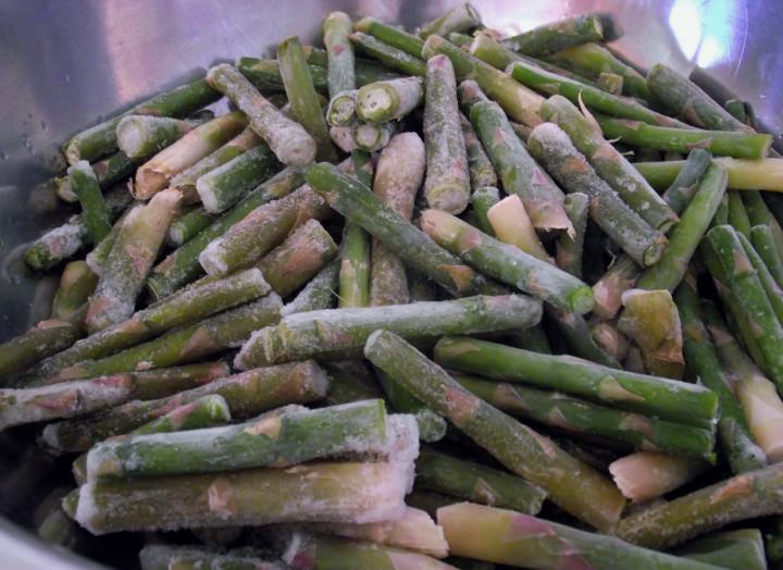 Frozen asparagus spear ends, in a bowl.